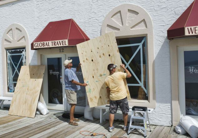 Men board up windows of their beachside property as they prepare for Hurrican Irene in Atlantic Beach